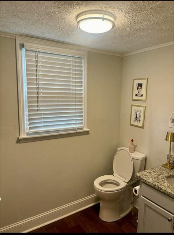 522 Oak Meadow Ln, Auburn, AL 36830 - half bath with wood finished floors, toilet, vanity, a textured ceiling, and baseboards