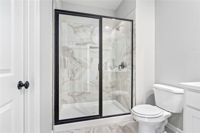 bathroom featuring vanity, toilet, and a shower with shower door