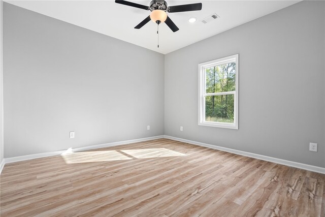 spare room with ceiling fan and light wood-type flooring