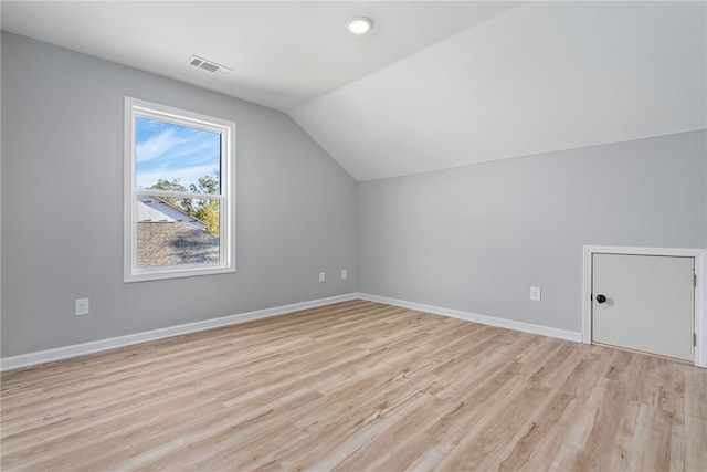 bonus room featuring light hardwood / wood-style flooring and lofted ceiling