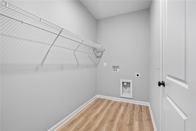 laundry area with hookup for an electric dryer, hardwood / wood-style flooring, and washer hookup