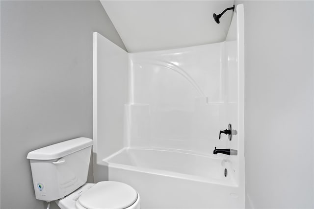 bathroom with shower / bath combination, lofted ceiling, and toilet