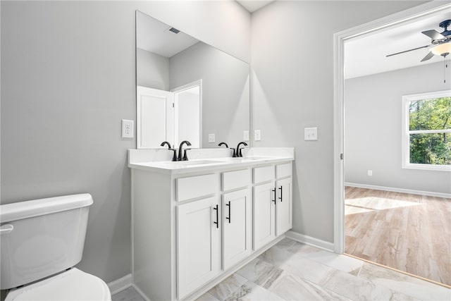 bathroom featuring vanity, ceiling fan, and toilet