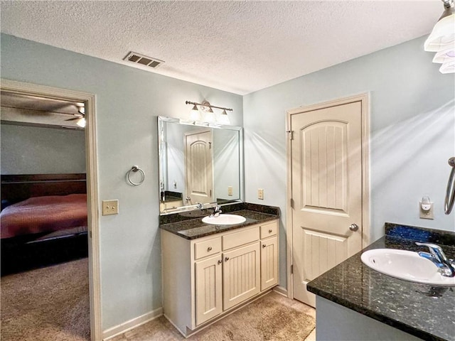 bathroom featuring vanity and a textured ceiling