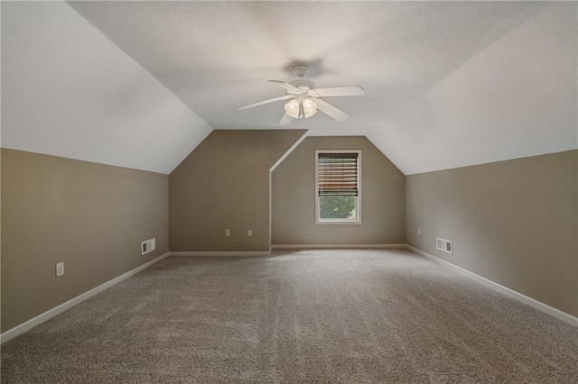 bonus room with lofted ceiling, carpet floors, a textured ceiling, and ceiling fan