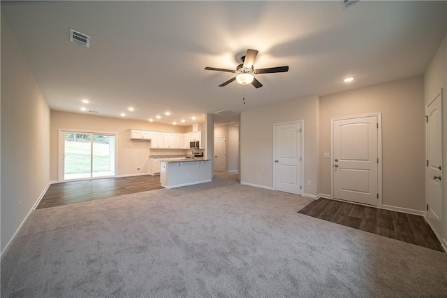 unfurnished living room with recessed lighting, visible vents, carpet floors, and a ceiling fan