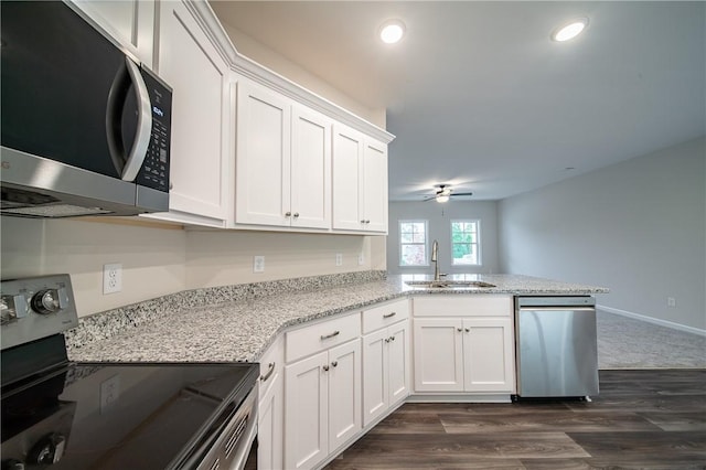 kitchen with ceiling fan, recessed lighting, stainless steel appliances, white cabinetry, and a sink