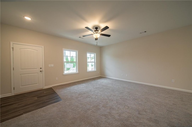 spare room featuring a ceiling fan, baseboards, visible vents, recessed lighting, and dark colored carpet