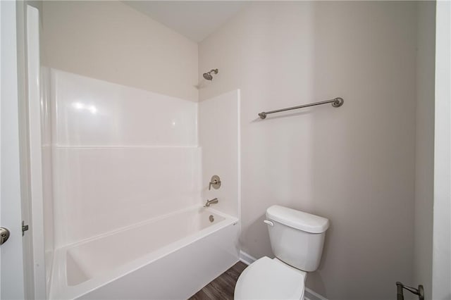 bathroom featuring shower / tub combination, toilet, and wood finished floors