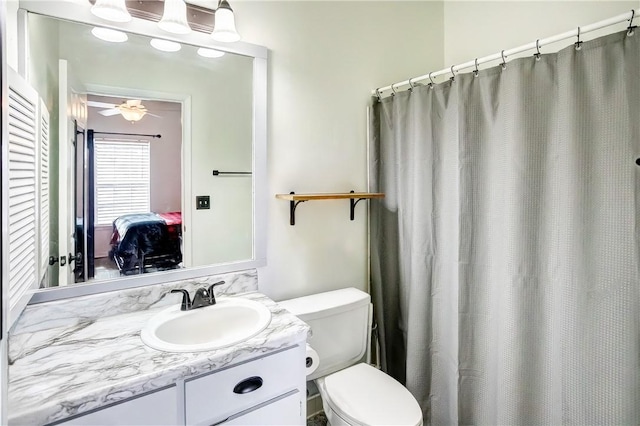 bathroom featuring a ceiling fan, vanity, toilet, and ensuite bathroom