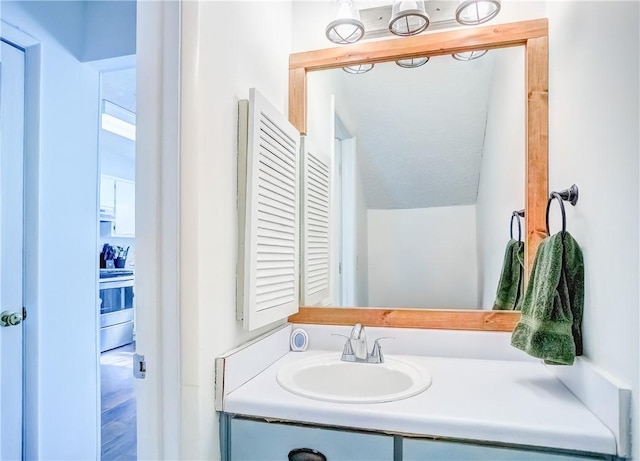 bathroom with vaulted ceiling and vanity