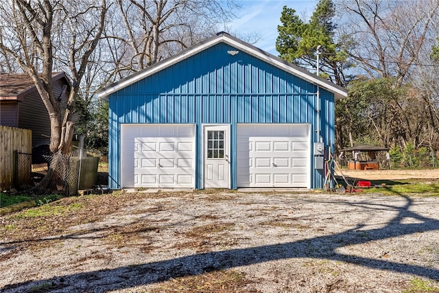 detached garage featuring fence