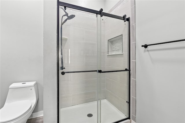 full bathroom with a shower stall and toilet