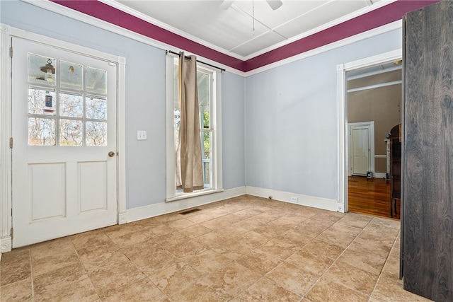 interior space with ornamental molding, a ceiling fan, visible vents, and baseboards