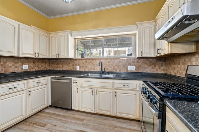 kitchen with stainless steel appliances, crown molding, cream cabinetry, under cabinet range hood, and a sink