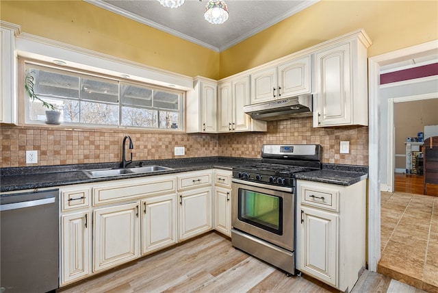 kitchen with backsplash, appliances with stainless steel finishes, ornamental molding, a sink, and under cabinet range hood