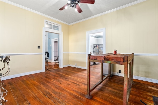 office area featuring baseboards, ceiling fan, ornamental molding, and dark wood-style flooring