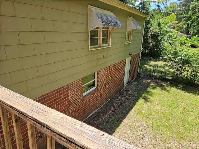 view of side of property featuring fence and a lawn