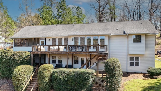 back of property featuring stairs and a deck