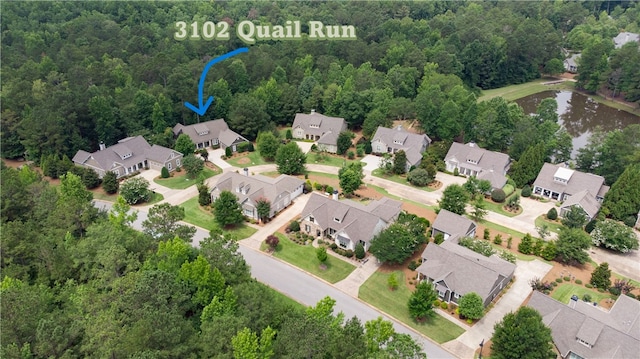 3102 Quail Run, Opelika, AL 36801 - aerial perspective of suburban area with a large body of water and a forest