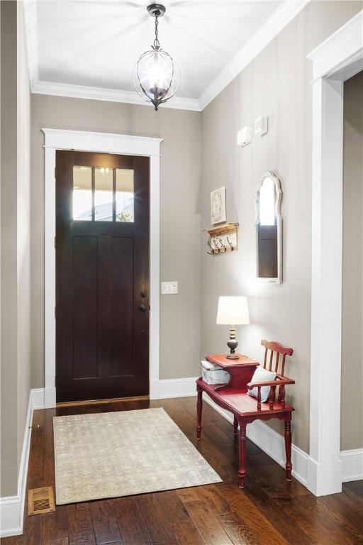 3102 Quail Run, Opelika, AL 36801 - entryway featuring hardwood / wood-style flooring, crown molding, and a chandelier