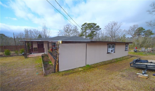 view of home's exterior with cooling unit and a yard