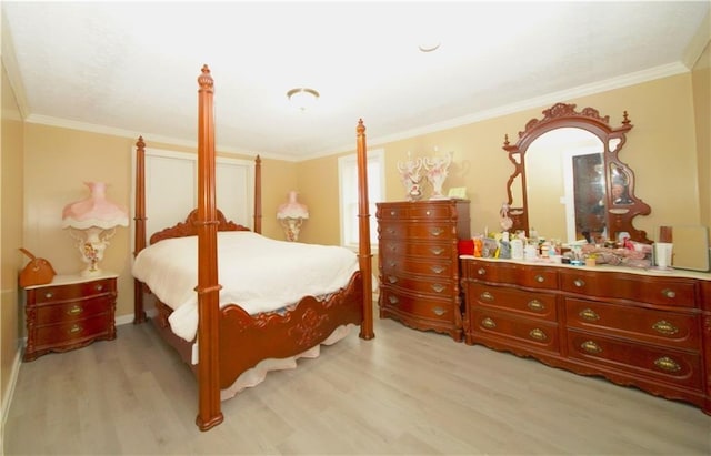 bedroom featuring light hardwood / wood-style flooring and crown molding