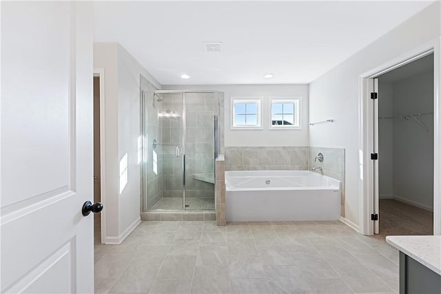 bathroom with tile patterned flooring, vanity, and separate shower and tub