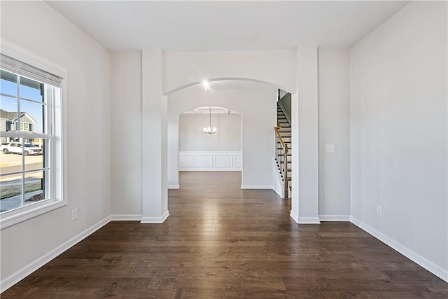 empty room with dark hardwood / wood-style floors