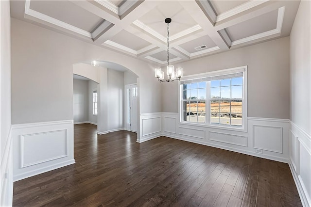 unfurnished dining area with beamed ceiling, a notable chandelier, dark hardwood / wood-style flooring, and coffered ceiling