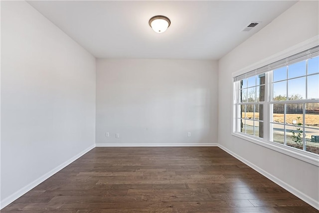 spare room featuring dark hardwood / wood-style floors