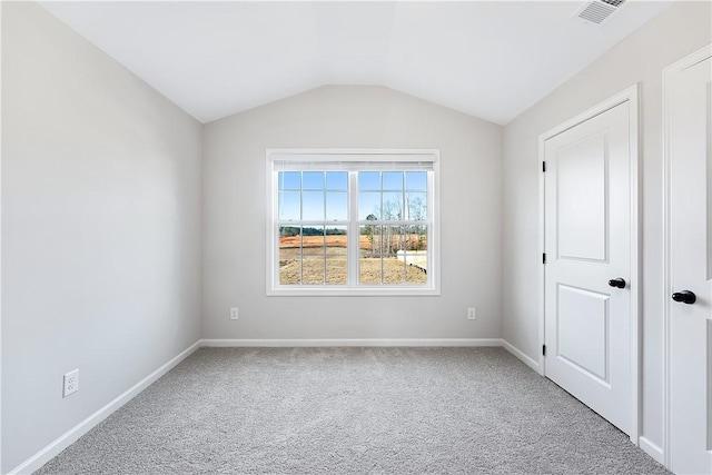 unfurnished bedroom featuring carpet flooring and lofted ceiling