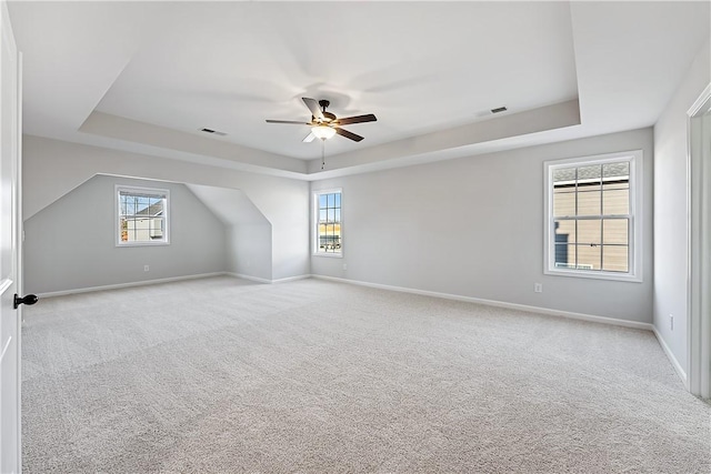 additional living space featuring ceiling fan and light colored carpet