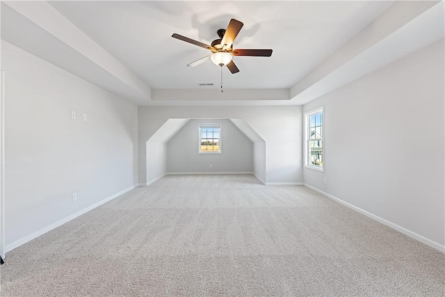 additional living space featuring light carpet and ceiling fan