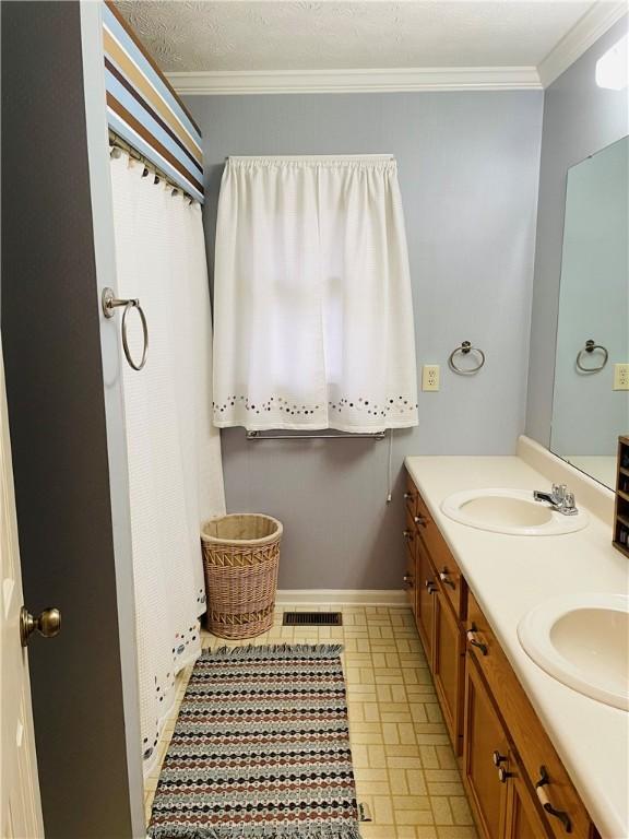335 Forsythia Ct, Auburn, AL 36830 - bathroom with crown molding and double vanity