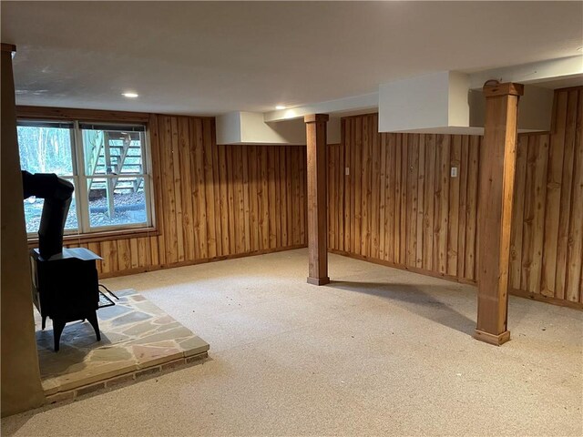 335 Forsythia Ct, Auburn, AL 36830 - below grade area with a wood stove, wood walls, and carpet flooring