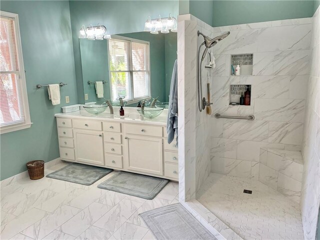 335 Forsythia Ct, Auburn, AL 36830 - bathroom featuring double vanity, tiled shower, and marble finish floors