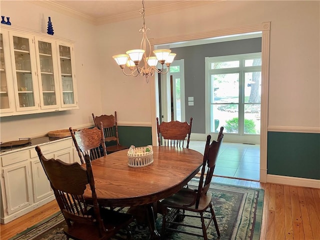 335 Forsythia Ct, Auburn, AL 36830 - dining space featuring a chandelier, ornamental molding, and light wood-style flooring