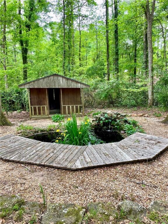 335 Forsythia Ct, Auburn, AL 36830 - view of yard with a shed and a forest view