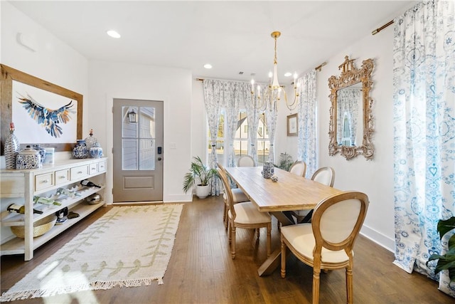 dining room featuring an inviting chandelier and dark hardwood / wood-style floors