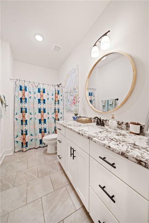 bathroom featuring vanity and toilet