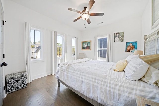 bedroom with ceiling fan and dark hardwood / wood-style floors