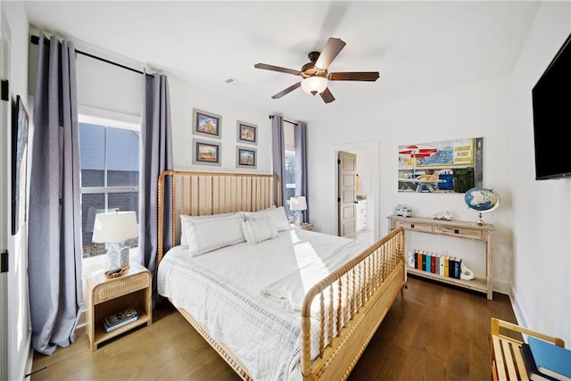 bedroom with dark hardwood / wood-style floors and ceiling fan