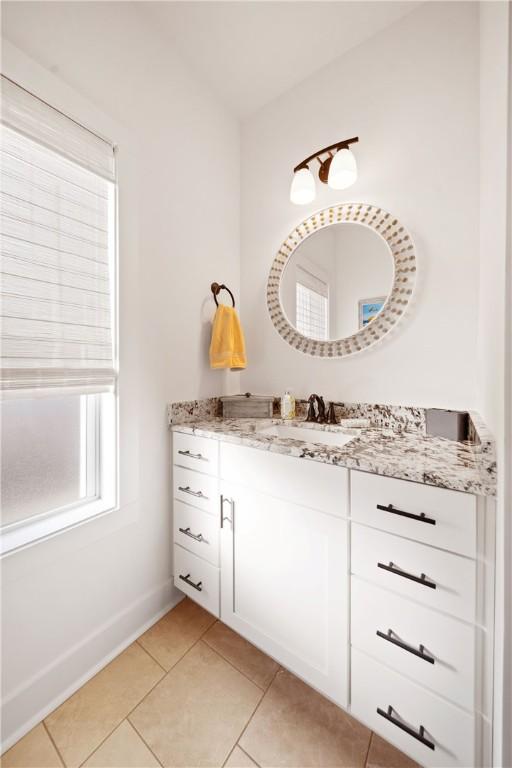 bathroom featuring tile patterned flooring and vanity