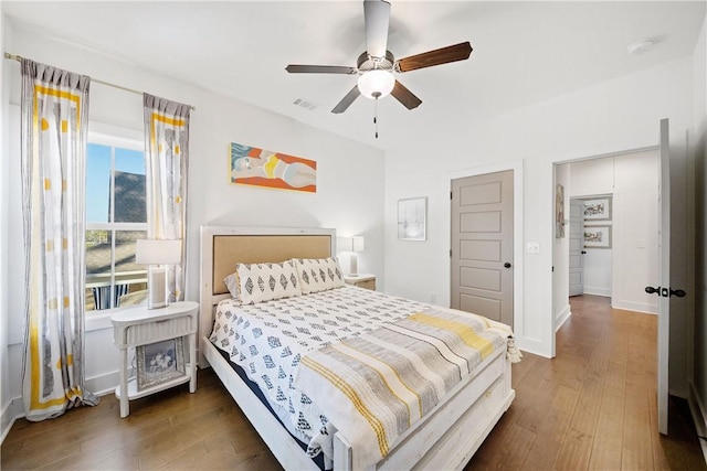 bedroom featuring ceiling fan and dark hardwood / wood-style flooring