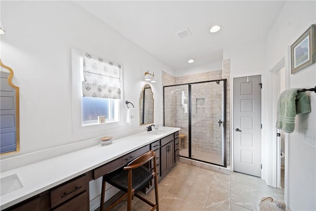 bathroom featuring vanity and a shower with shower door