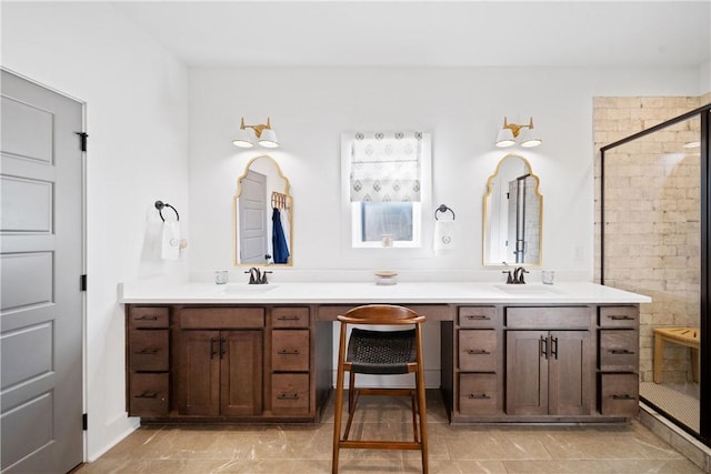 bathroom with vanity and a shower with shower door