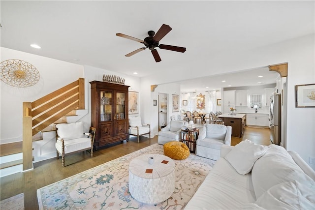 living room with dark hardwood / wood-style floors and ceiling fan