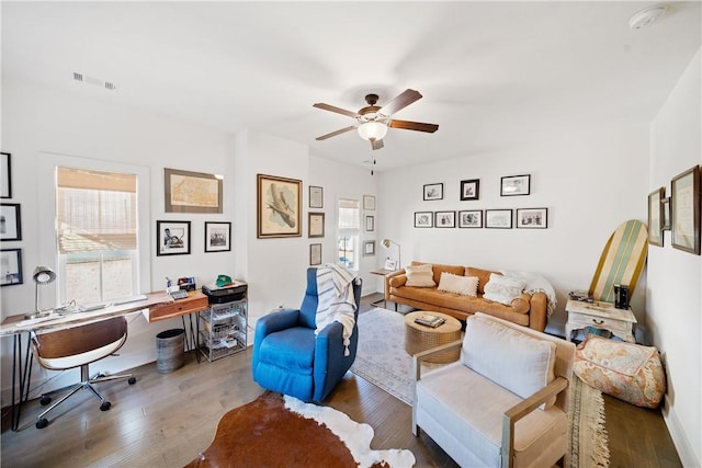 living room with ceiling fan and wood-type flooring