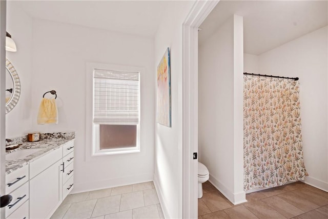 bathroom featuring tile patterned floors, vanity, and toilet